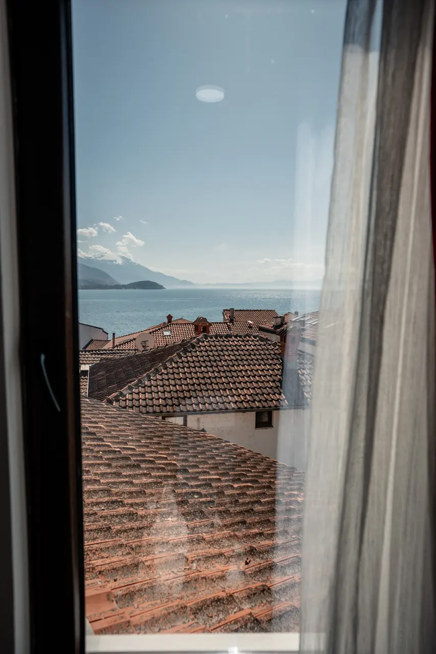 Window view: roofs and side view of the lake, portrait