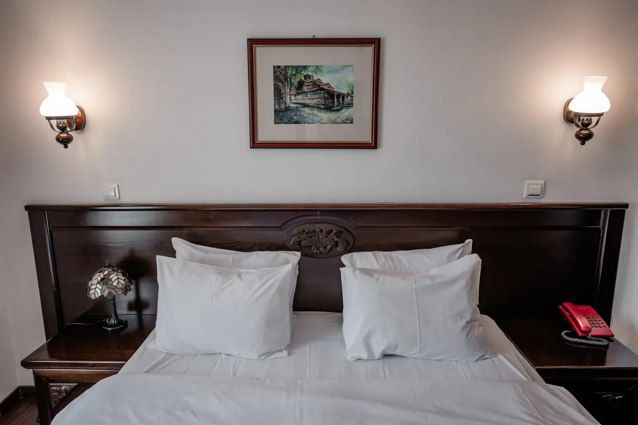 Headboard with wall lamps and painting