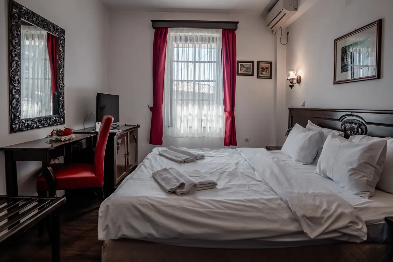Wide: carved mirror, desk, bed and window