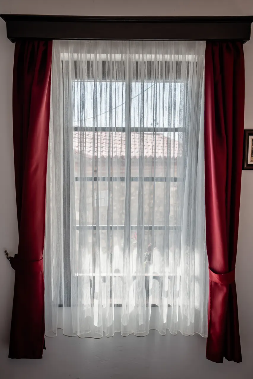 Window with red curtains and sheers, portrait