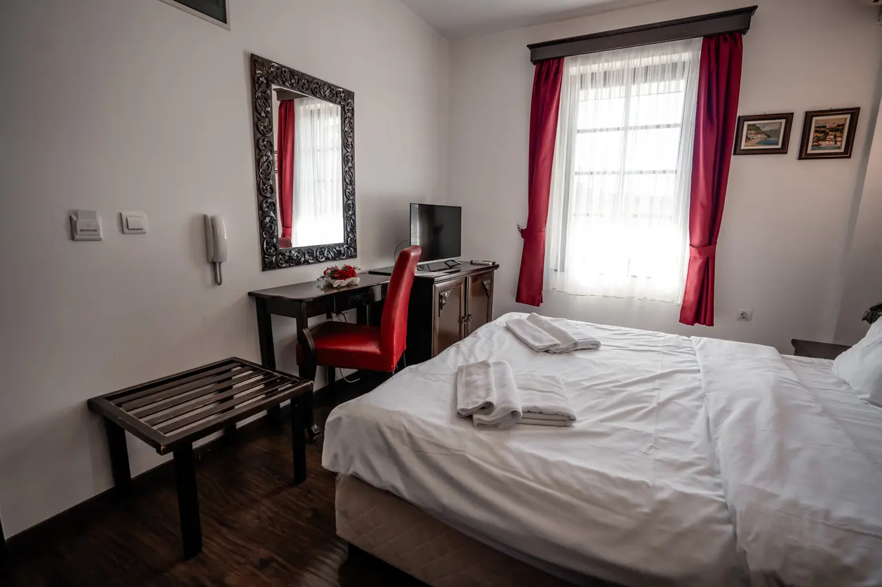 Room from the doorway: bed, desk and window