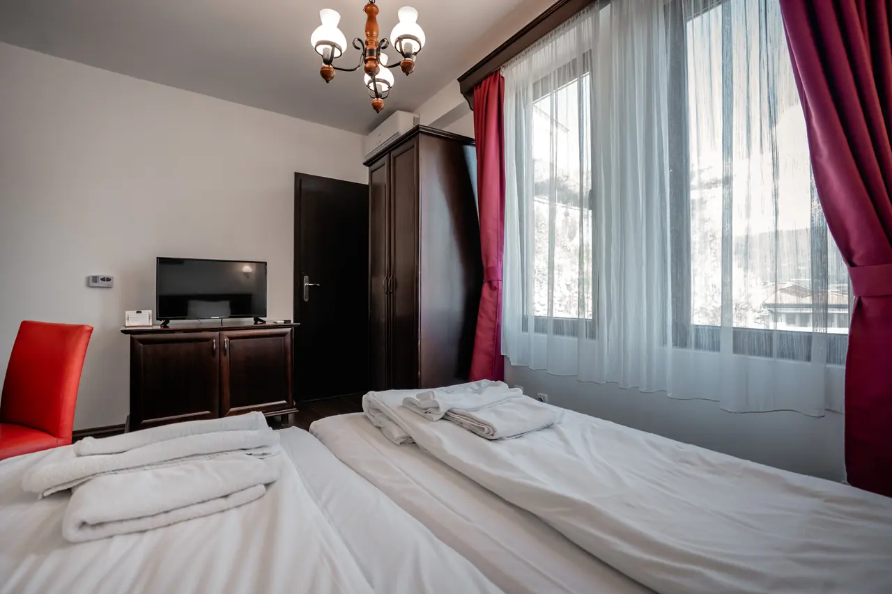 Beds, windows and chandelier