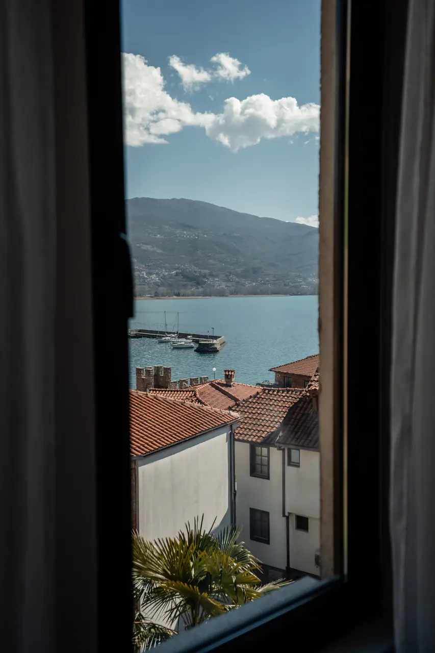 Window view of lake and mountain, dark frame, portrait