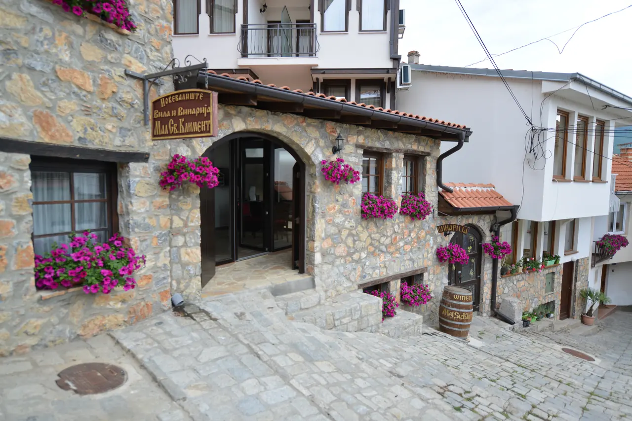 The villa's entrance with its sign and window boxes of magenta petunias