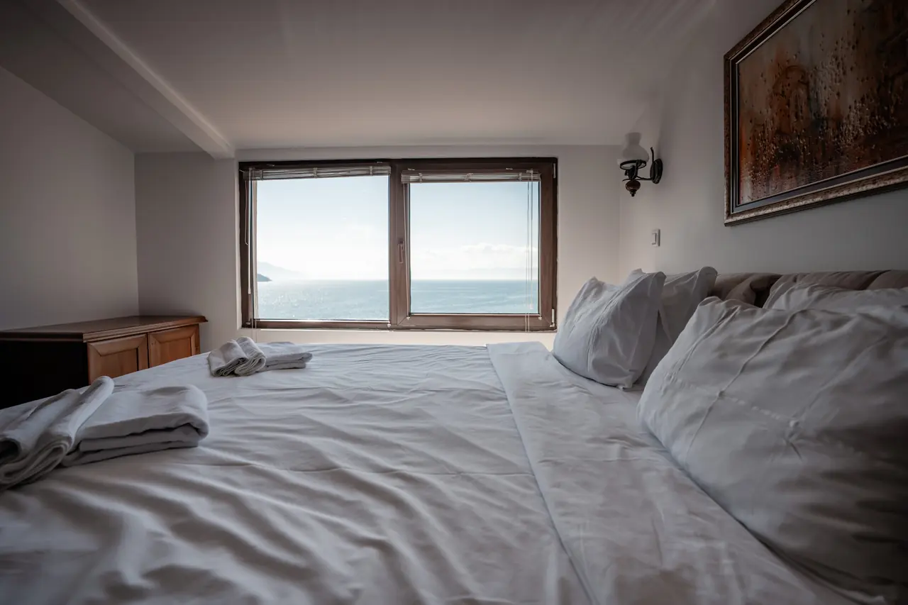 Bed close-up with window and lake